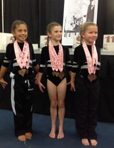Three Girls Standing with Medals